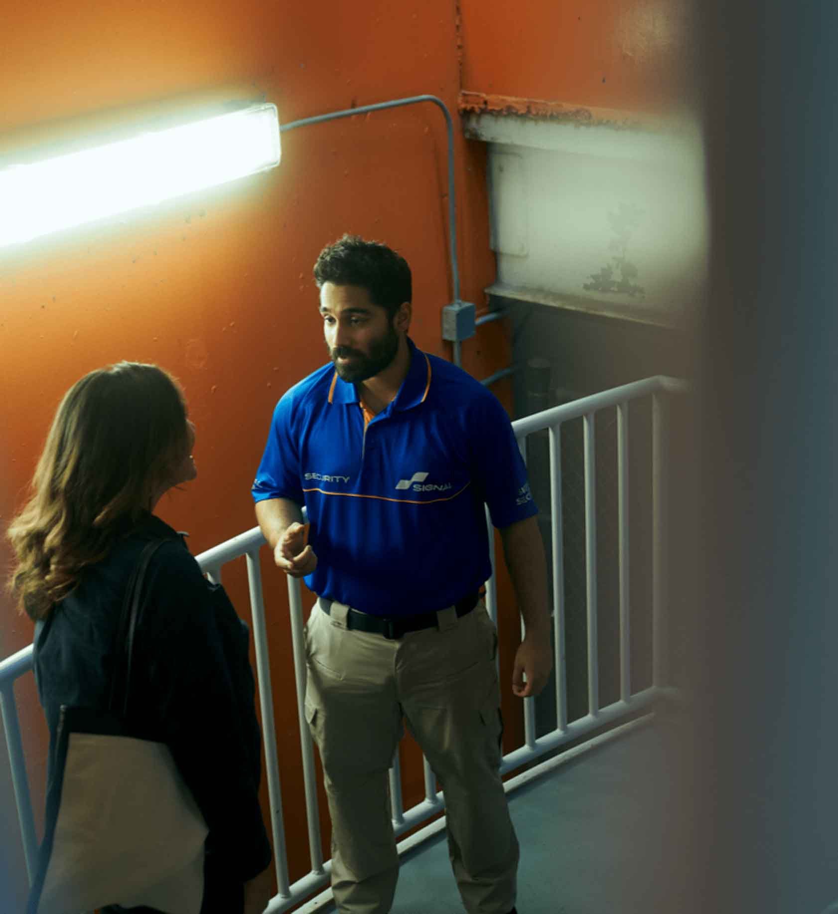 Signal employee talking to someone in a hallway